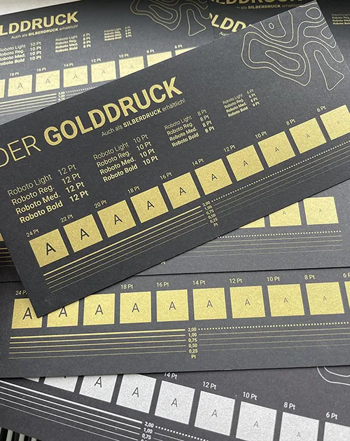Goldruck und Silberdruck auf einem schwarzen Karton